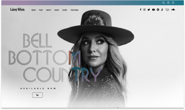 Homepage design for LaineyWilson.com features a visually striking, country-themed aesthetic with a large, engaging photo of Lainey Wilson prominently displayed. The layout includes intuitive navigation links to music, tour dates, merchandise, and a fan club sign-up. The design incorporates rustic textures and warm, earthy tones, capturing the essence of Lainey Wilson's music and personal brand, inviting fans to explore and connect with her work.